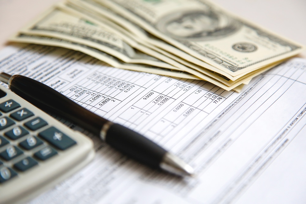 money, papers, and a calculator