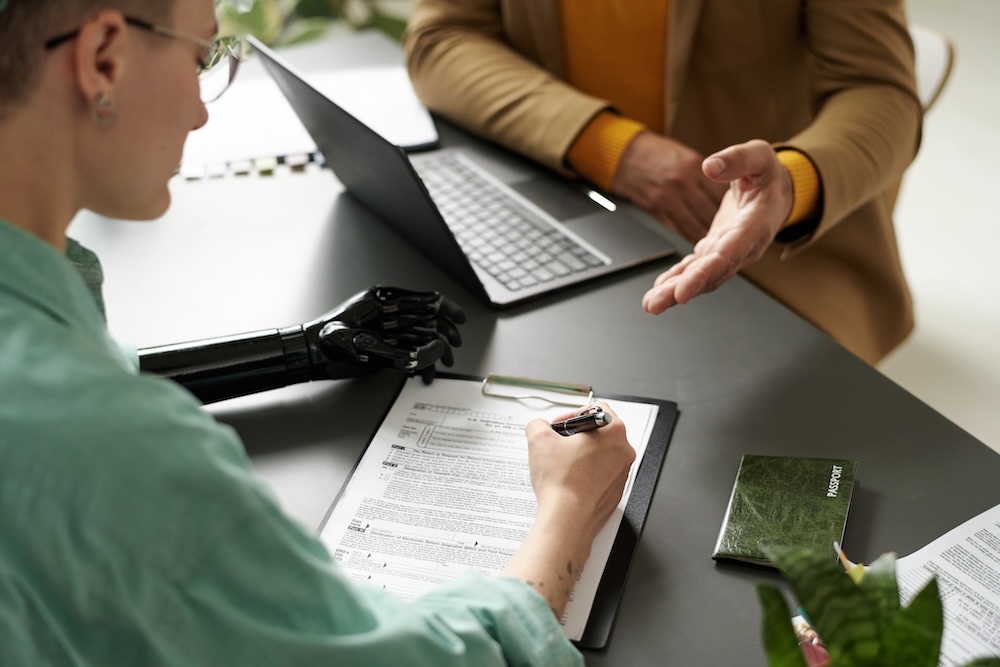 Woman Filing Application With insurance Agent