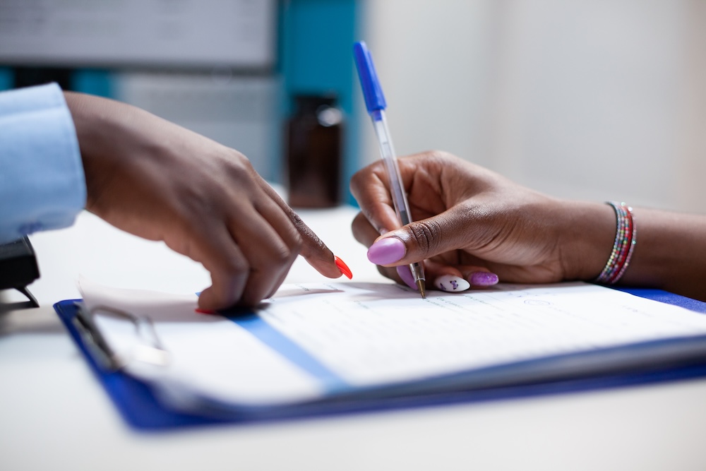 a person signing a medical form