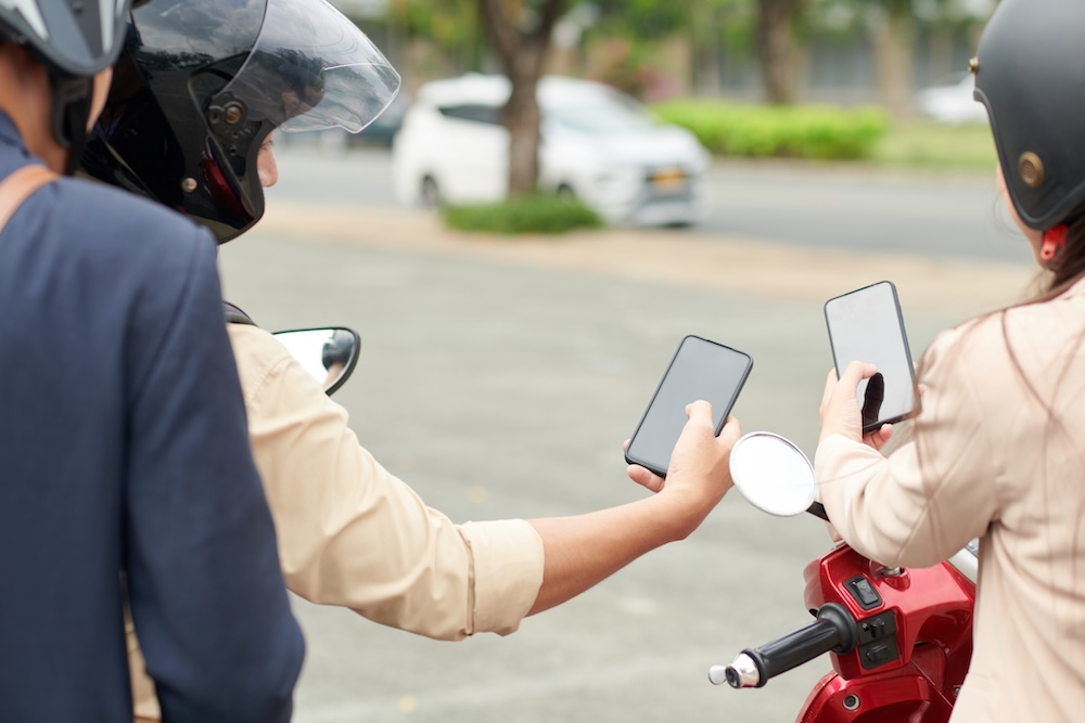 two people looking at their phones for directions